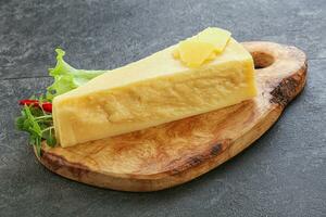 Parmesan cheese piece over board photo