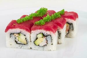 Maki Sushi - Roll made of Crab, avocado, cucumber inside. Fresh Tuna and tobico roe outside photo