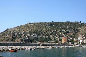 Port Alanya and red brick tower photo