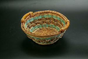 Natural wicker tableware for serving over black photo