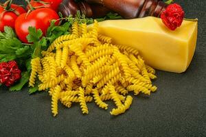 Raw Italian pasta Fusilli for cooking photo