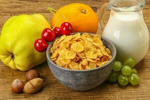 Breakfast with corn flakes and milk photo