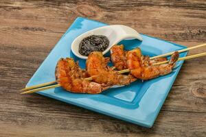 Grilled prawn skewer with pepper sauce photo