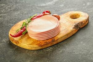 Sliced pork sausages stack over board photo