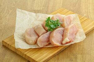 Raw chicken breast slices for cooking photo