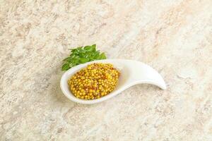 Grain mustard sauce in the bowl photo