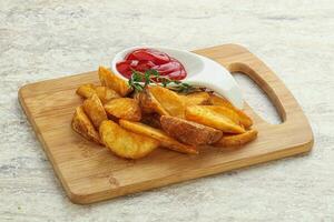 Fried rustic potato with tomato ketcup photo