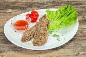 Grilled Thick pork steak served salad photo