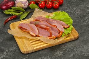 Sliced smoked duck breast served salad photo