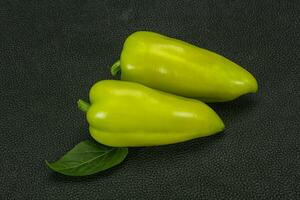 Green bell pepper over wooden background photo