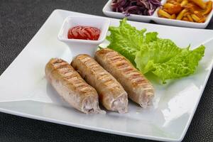 Grilled sausages served mushrooms and cabbage photo