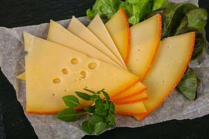 Sliced yellow Swiss cheese photo