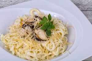 Italian pasta with mussels and cheese photo