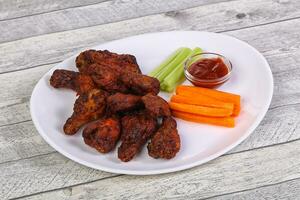 Chicken wings bbq with celery and carrot photo