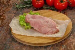 Raw Turkey steak served rosemary photo