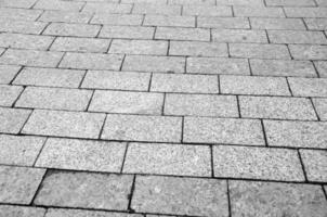 Bricks and stones city pavement pattern, road texture black and white background photo