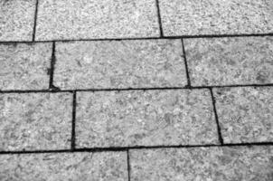 City pavement texture, brick road pattern made of granite black and white background photo