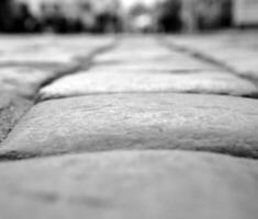 Stones of road pavement close view black and white background photo