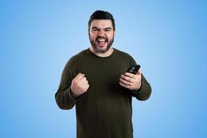 Front View Portrait of Man Gesturing and Shouting Under Clear Blue Sky photo