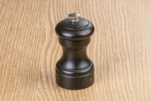Wooden pepper mill for kitchen photo