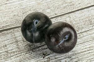 Two ripe sweet black plums photo