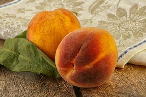 Two ripe sweet peaches fruit photo