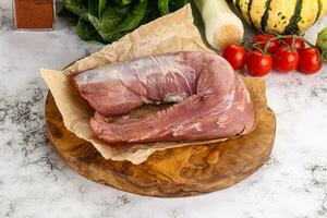 Uncooked raw pork tenderloin with spices photo