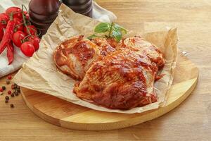 Marinated chicken leg in tomato sauce photo