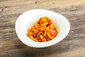 Marinated pickled honey mushrooms in the bowl photo