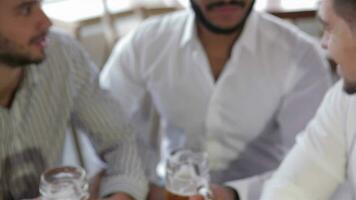 Three young men in casual wear toasting video