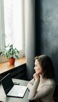 Effortless Online Shopping. Young Woman with Credit Card and Laptop. Young woman holding credit card and using laptop computer. Online shopping concept photo