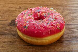 Sweet glazed struwberry donut with icing photo