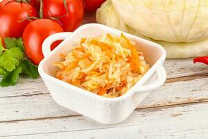 Fermented cabbage sauerkraut in the bowl photo