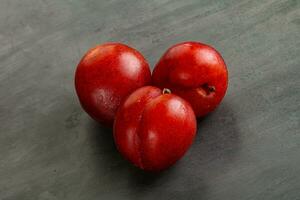 Ripe sweet juicy red plum photo