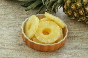 Marinated pineapple rings in the bowl photo