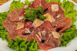 Beef carpaccio with parmesan cheese photo