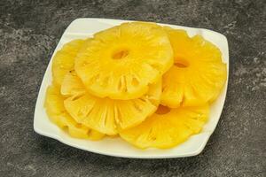 Marinated pineapple rings in the bowl photo