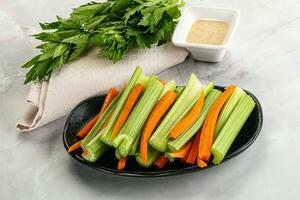 Vegan cuisine - dietary celery and carrot cticks photo