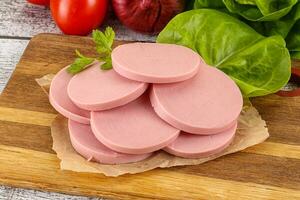 Slices boiled sausages for breakfast photo