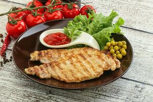 Grilled pork steak with ketchup photo