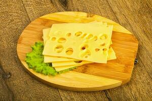Sliced cheese over board photo