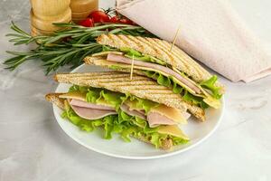 Homemade club sandwich with ham and cheese photo