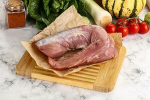 Uncooked raw pork tenderloin with spices photo