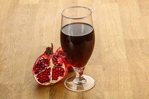 Sweet pomegranate juice in glass photo