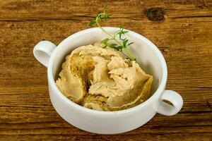 Humus over wooden background photo