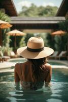 Back view of young woman in hat standing in swimming pool at resort. AI Generative photo