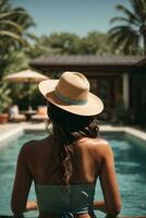 Back view of young woman in hat standing in swimming pool at resort. AI Generative photo