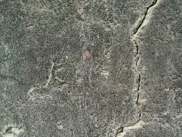 Grungy wall of gray concrete texture with cracked surface from sand and cement materials. photo