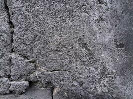 Grungy wall of gray concrete texture with cracked surface from sand and cement materials. photo