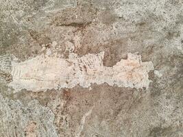 Grungy wall of gray concrete texture with cracked surface from sand and cement materials. photo